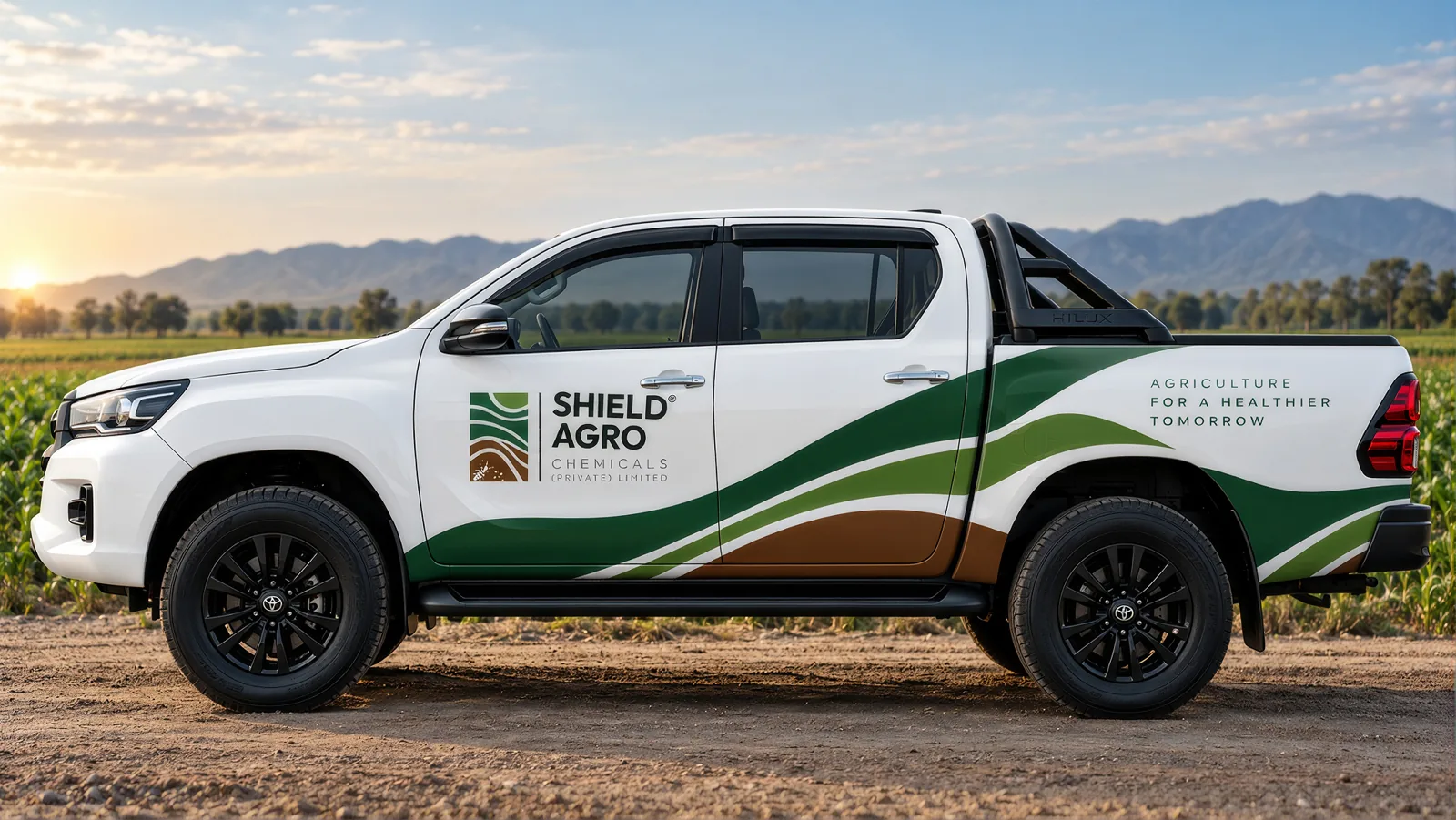 Shield Agro pickup with spraying equipment parked at a farmhouse gate